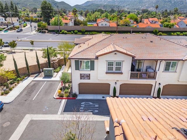 view of front facade with an attached garage, stucco siding, and a mountain view