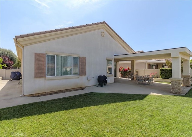 1643 Landmark Way, Beaumont, CA 92223 - rear view of property featuring a patio area, stucco siding, fence, and a lawn
