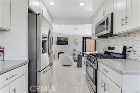 1440 Holbrook St, Eagle Rock, CA 90041 - kitchen with white cabinets, recessed lighting, stainless steel appliances, and backsplash