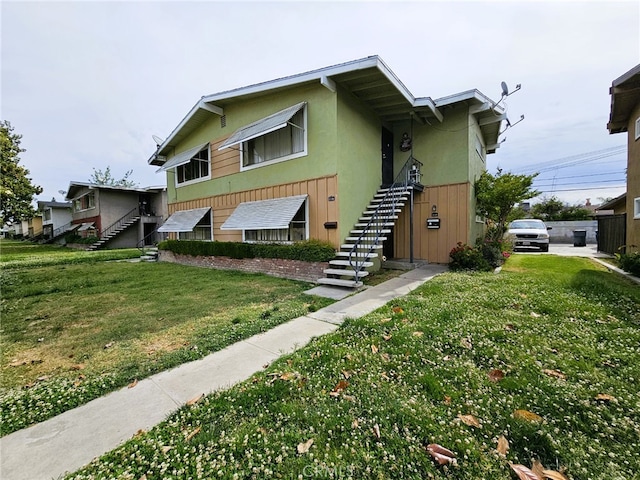 3734 N Abby St, Fresno, CA 93726 - view of front facade with stairway, stucco siding, and a front yard