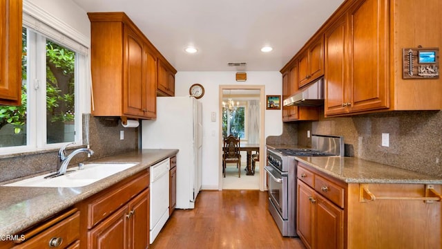 10424 Mcvine Ave, Sunland, CA 91040 - kitchen with white appliances, a sink, under cabinet range hood, dark wood finished floors, and backsplash