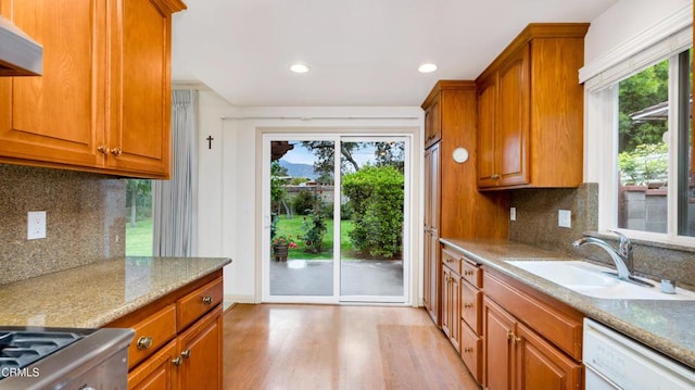 10424 Mcvine Ave, Sunland, CA 91040 - kitchen with white dishwasher, a sink, healthy amount of natural light, light wood-style floors, and recessed lighting