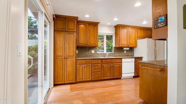 10424 Mcvine Ave, Sunland, CA 91040 - kitchen featuring white appliances, brown cabinets, backsplash, recessed lighting, and light wood-style floors