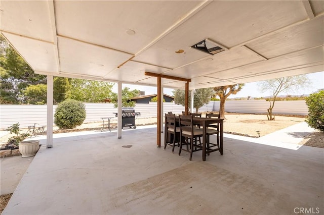 view of patio / terrace with outdoor dining space, grilling area, and a fenced backyard