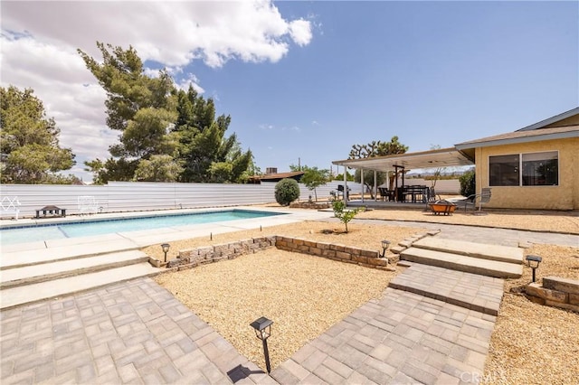 pool with a patio and fence private yard