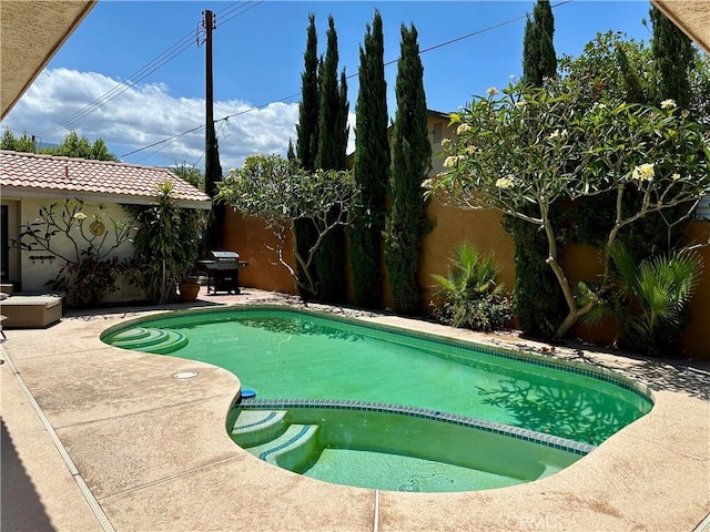 52295 Avenida Vallejo Ln, Quinta, CA 92253 - view of pool featuring a patio, a fenced backyard, a grill, and a pool with connected hot tub