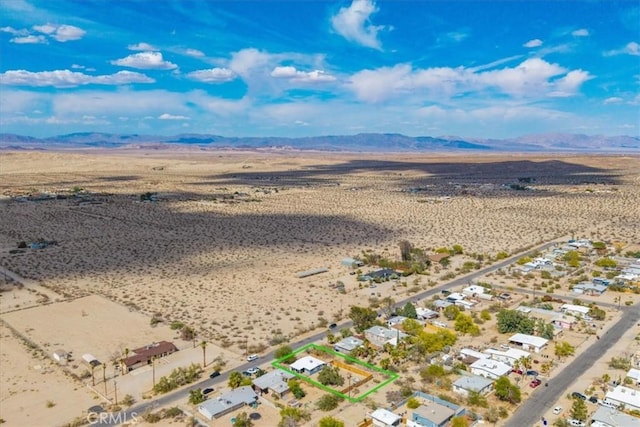 74825 Alta Loma Dr Unit 29, Palms, CA 92277 - aerial view of sparsely populated area with a desert landscape, a mountainous background, and property parcel outlined