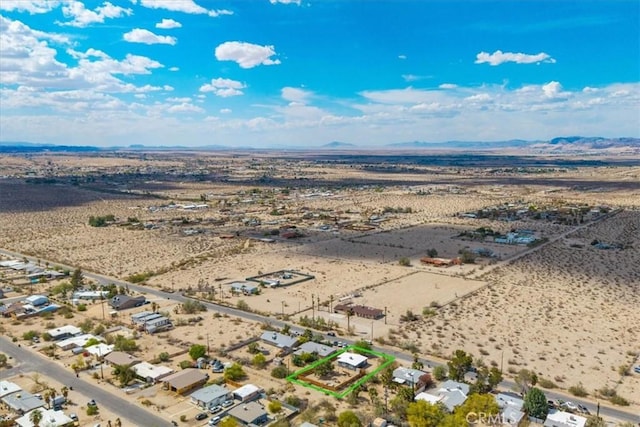 74825 Alta Loma Dr Unit 29, Palms, CA 92277 - aerial view of sparsely populated area featuring a desert landscape, property parcel outlined, and a mountainous background