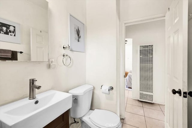 74825 Alta Loma Dr Unit 29, Palms, CA 92277 - bathroom featuring a heating unit, a sink, toilet, and tile patterned flooring
