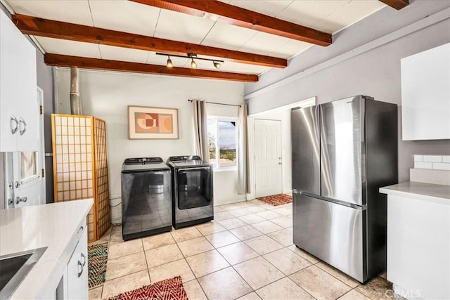 74825 Alta Loma Dr Unit 29, Palms, CA 92277 - kitchen featuring freestanding refrigerator, independent washer and dryer, white cabinetry, light countertops, and beam ceiling