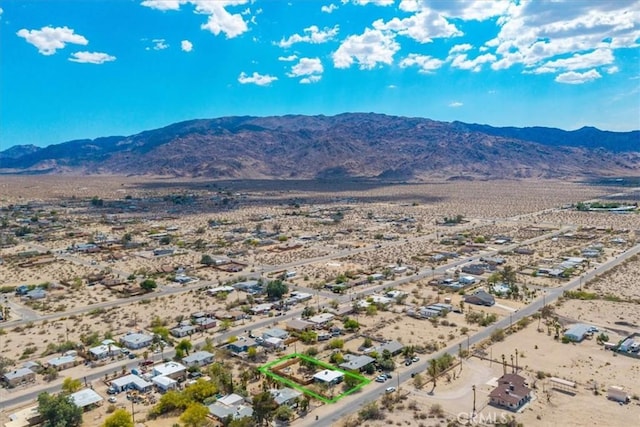 74825 Alta Loma Dr Unit 29, Palms, CA 92277 - aerial view of property and surrounding area featuring a mountainous background, a desert landscape, and property parcel outlined
