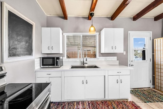 74825 Alta Loma Dr Unit 29, Palms, CA 92277 - kitchen featuring appliances with stainless steel finishes, a sink, beamed ceiling, light countertops, and white cabinets