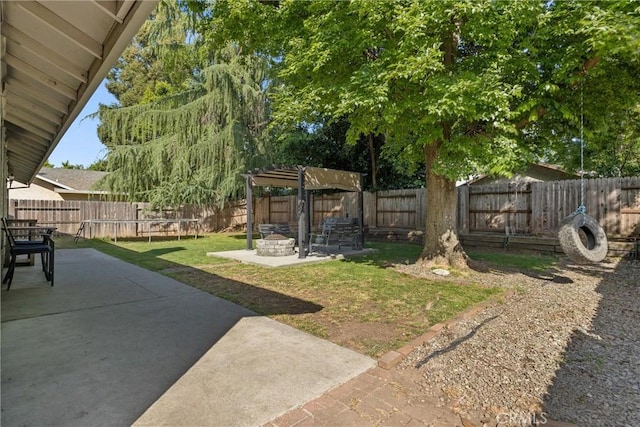 view of yard with a fire pit, a patio, and a fenced backyard