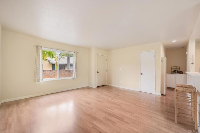 552 Canyon Dr Unit 15, Oceanside, CA 92054 - unfurnished living room with light wood finished floors and baseboards