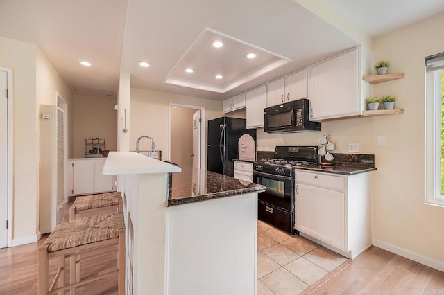 552 Canyon Dr Unit 15, Oceanside, CA 92054 - kitchen with black appliances, baseboards, white cabinets, recessed lighting, and a tray ceiling