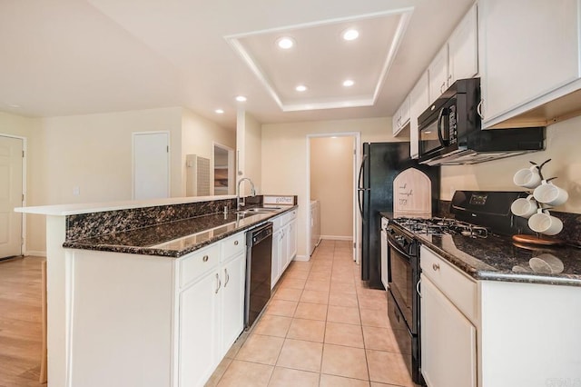 552 Canyon Dr Unit 15, Oceanside, CA 92054 - kitchen with a sink, black appliances, washer and dryer, a peninsula, and white cabinets