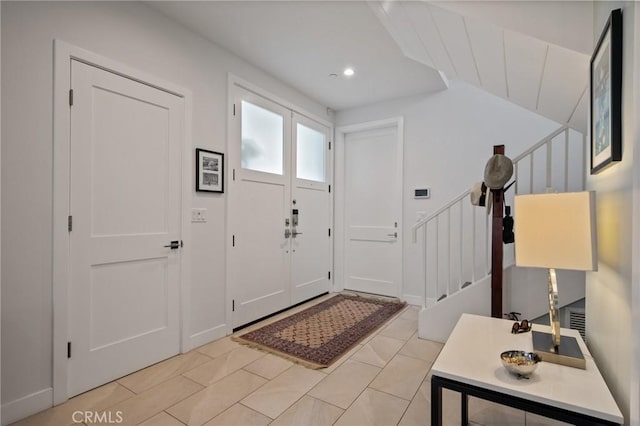 foyer featuring stairway and recessed lighting