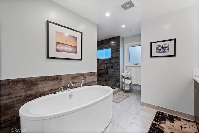 full bathroom with recessed lighting, visible vents, a shower stall, vanity, and a freestanding bath