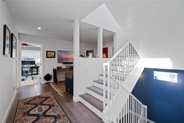 staircase with a ceiling fan, wood finished floors, baseboards, and recessed lighting