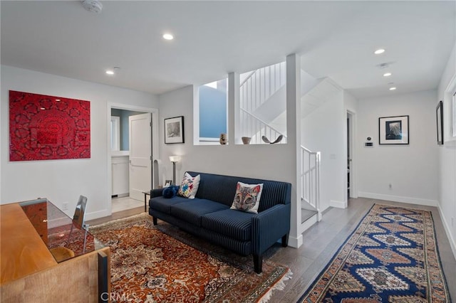 living room featuring stairway, wood finished floors, baseboards, and recessed lighting