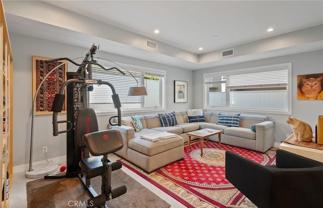 living area featuring baseboards, visible vents, and recessed lighting