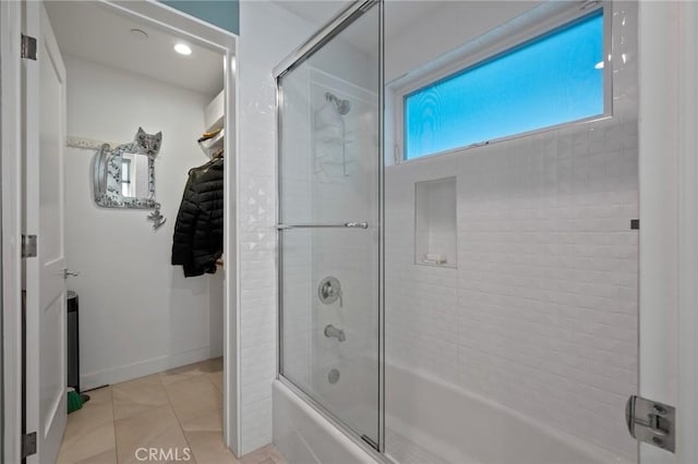 full bath featuring tile patterned floors, enclosed tub / shower combo, and baseboards