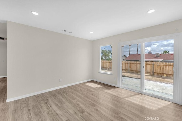 unfurnished room featuring baseboards, light wood-style floors, and recessed lighting