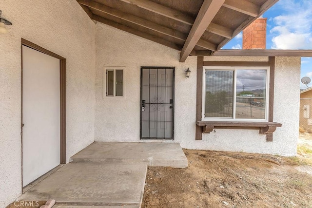 entrance to property with stucco siding