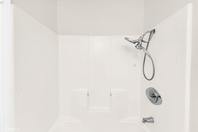 interior details with shower / tub combination