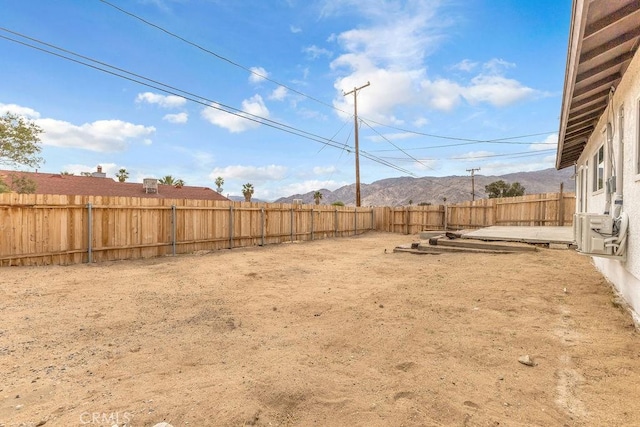 view of yard with a mountain view and a fenced backyard