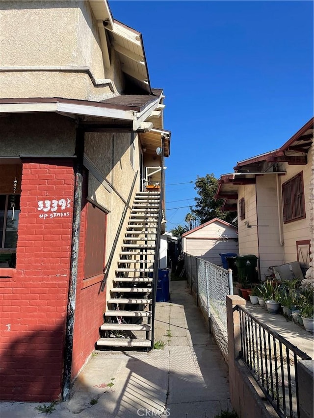 3339 Jeffries Ave, Los Angeles, CA 90065 - view of property exterior with stairway, fence, stucco siding, and brick siding