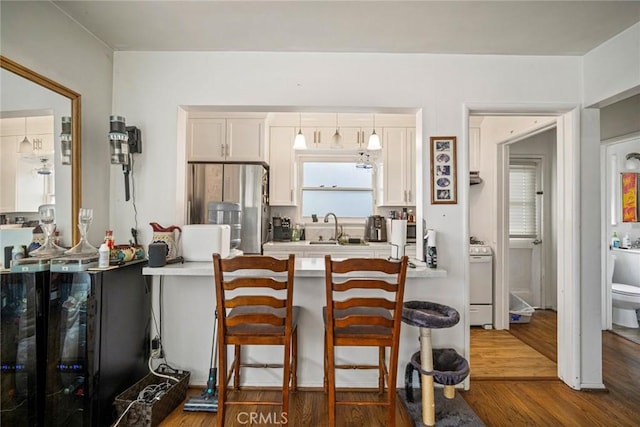 227 Avenida Santa Barbara, San Clemente, CA 92672 - kitchen with a kitchen breakfast bar, light countertops, gas range gas stove, and white cabinets