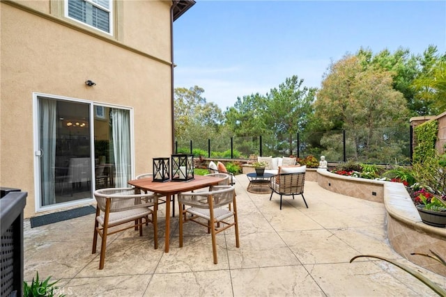 view of patio featuring an outdoor hangout area and fence