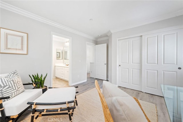 interior space featuring light wood-style flooring, baseboards, and ornamental molding