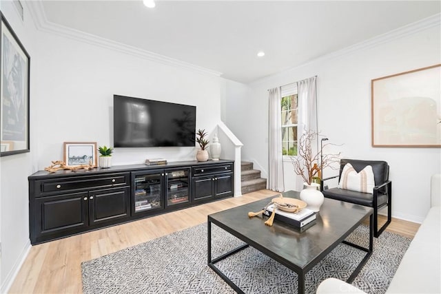 living area featuring stairs, ornamental molding, recessed lighting, and light wood-type flooring