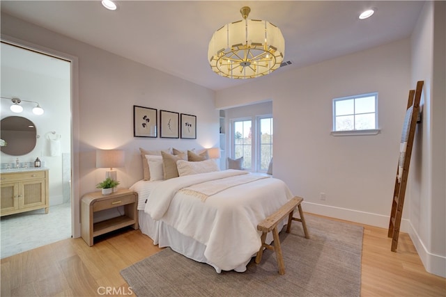 582 Paseo St, Arroyo Grande, CA 93420 - bedroom with a chandelier, light wood-type flooring, recessed lighting, ensuite bathroom, and baseboards