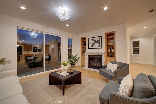 582 Paseo St, Arroyo Grande, CA 93420 - living area featuring a fireplace with flush hearth, light wood-type flooring, built in shelves, and recessed lighting