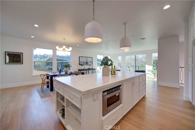 582 Paseo St, Arroyo Grande, CA 93420 - kitchen featuring a kitchen island, stainless steel microwave, light wood-style flooring, baseboards, and recessed lighting