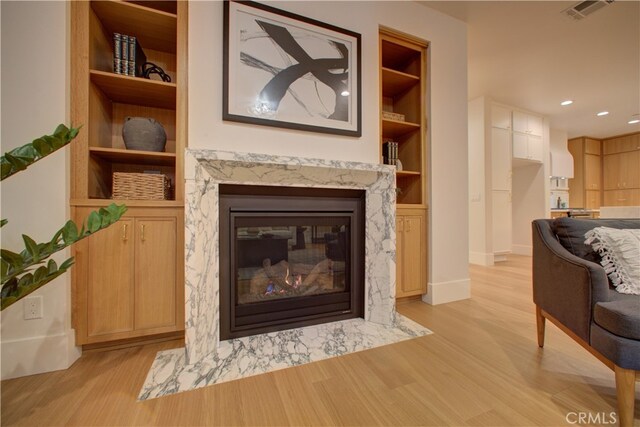 582 Paseo St, Arroyo Grande, CA 93420 - living area with light wood-style floors, built in features, baseboards, a fireplace, and recessed lighting