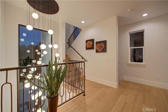 582 Paseo St, Arroyo Grande, CA 93420 - corridor featuring wood finished floors, baseboards, recessed lighting, and an upstairs landing