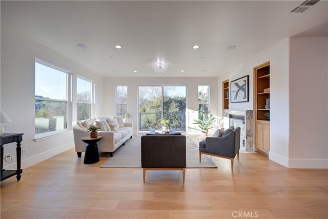 582 Paseo St, Arroyo Grande, CA 93420 - living room with baseboards, recessed lighting, light wood-type flooring, a high end fireplace, and built in features