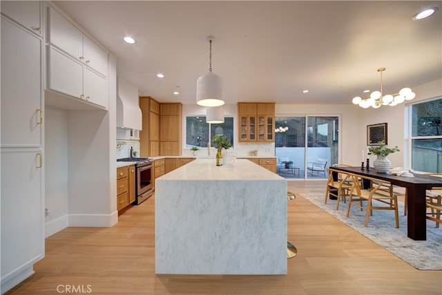 582 Paseo St, Arroyo Grande, CA 93420 - kitchen featuring stainless steel range with gas cooktop, wall chimney exhaust hood, recessed lighting, light wood-type flooring, and decorative backsplash