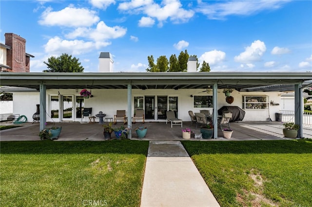 36608 Oak Ridge Dr, Yucaipa, CA 92399 - back of property featuring a lawn, a ceiling fan, a chimney, and a patio area