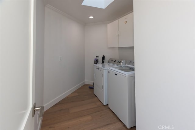 1624 Malden St, San Diego, CA 92109 - washroom with a skylight, washer and clothes dryer, cabinet space, light wood finished floors, and crown molding