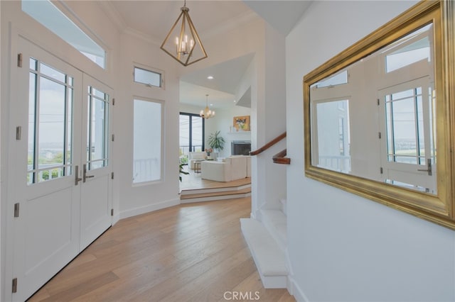 1624 Malden St, San Diego, CA 92109 - foyer featuring a chandelier, plenty of natural light, light wood-style floors, crown molding, and stairs