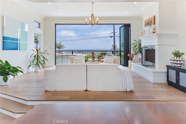 1624 Malden St, San Diego, CA 92109 - unfurnished living room featuring ornamental molding, a chandelier, a fireplace with raised hearth, wood finished floors, and recessed lighting