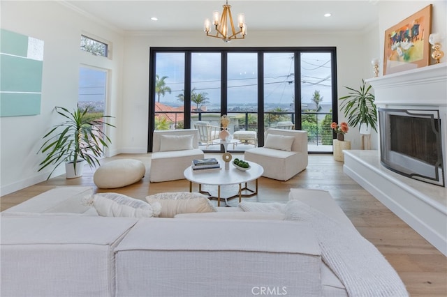 1624 Malden St, San Diego, CA 92109 - living area with crown molding, a fireplace with raised hearth, a chandelier, healthy amount of natural light, and recessed lighting