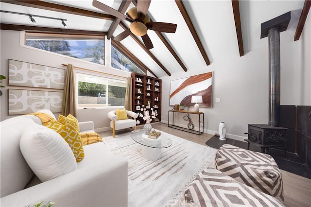21128 Trigger Ln, Diamond Bar, CA 91765 - living room with a wood stove, ceiling fan, baseboards, and wood finished floors