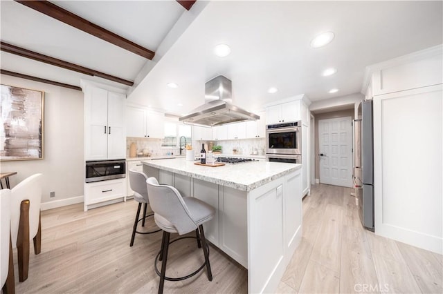 21128 Trigger Ln, Diamond Bar, CA 91765 - kitchen featuring island range hood, appliances with stainless steel finishes, backsplash, white cabinetry, and recessed lighting