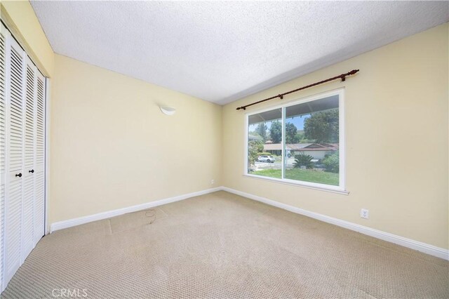 21128 Trigger Ln, Diamond Bar, CA 91765 - unfurnished bedroom with carpet, a closet, baseboards, and a textured ceiling